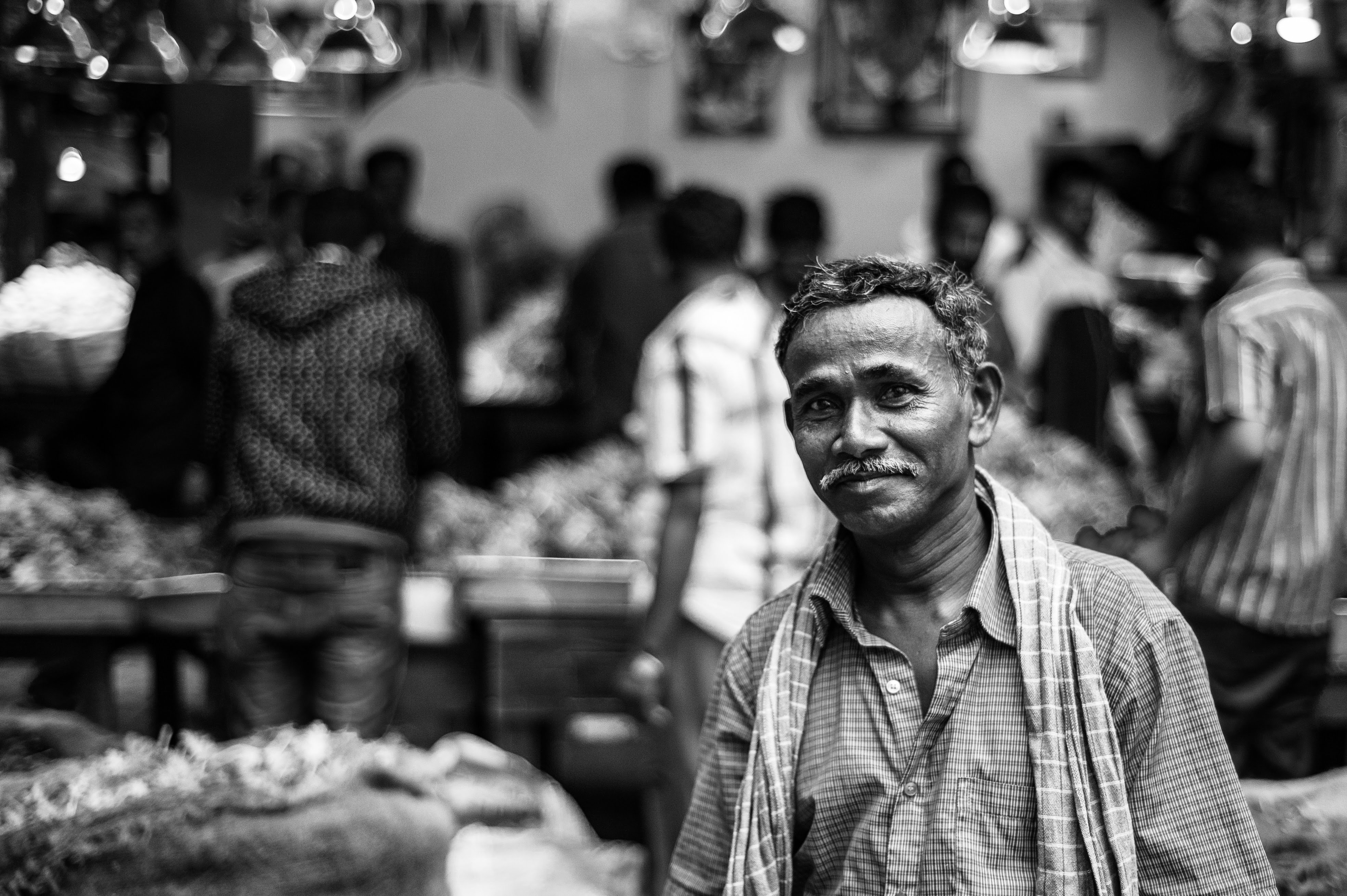 A black and white portrait of a manual labourer taking a break. 