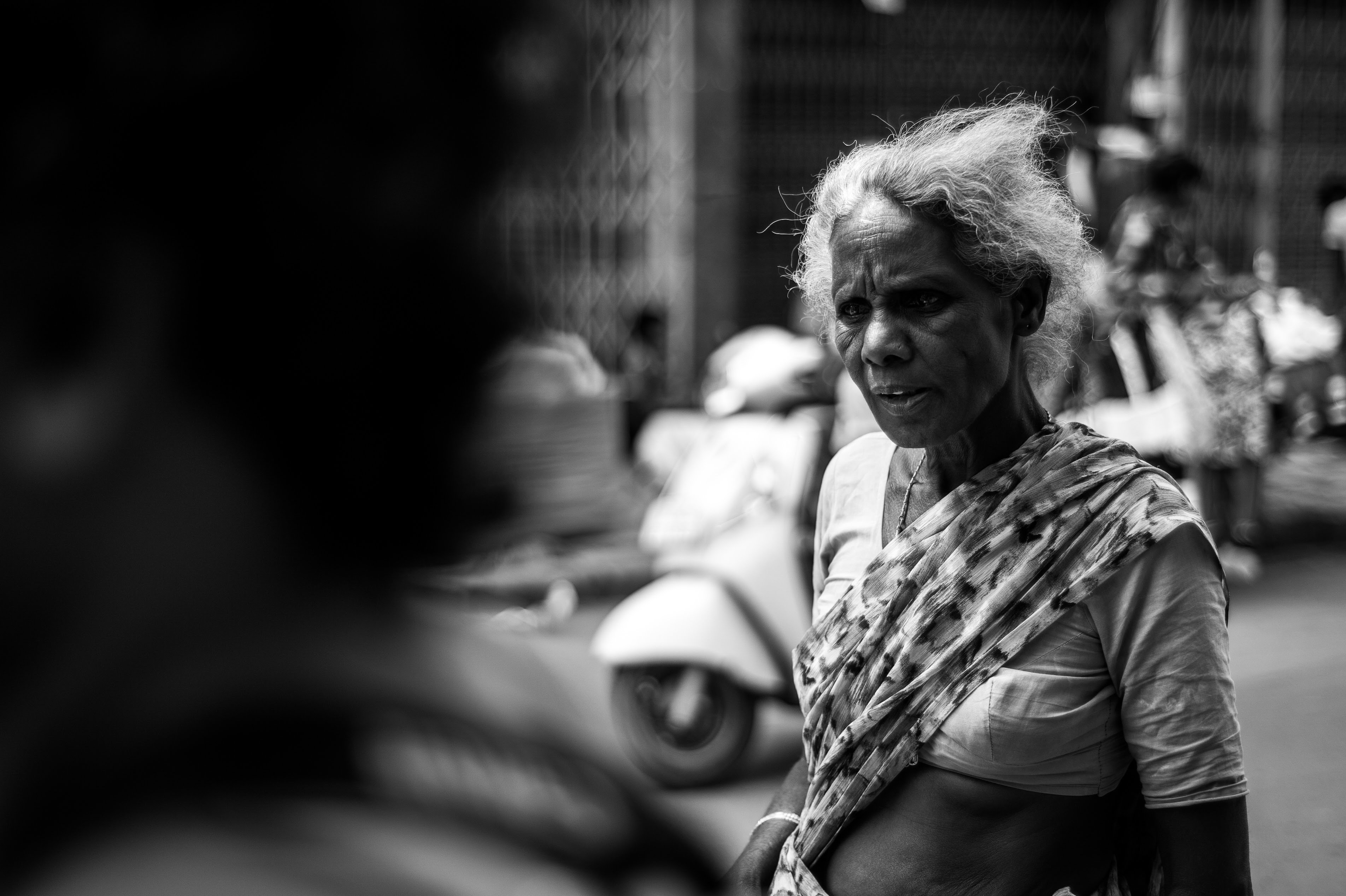 A black and white portrait of a feisty tamarind vendor (female) who didn't like her picture taken. 