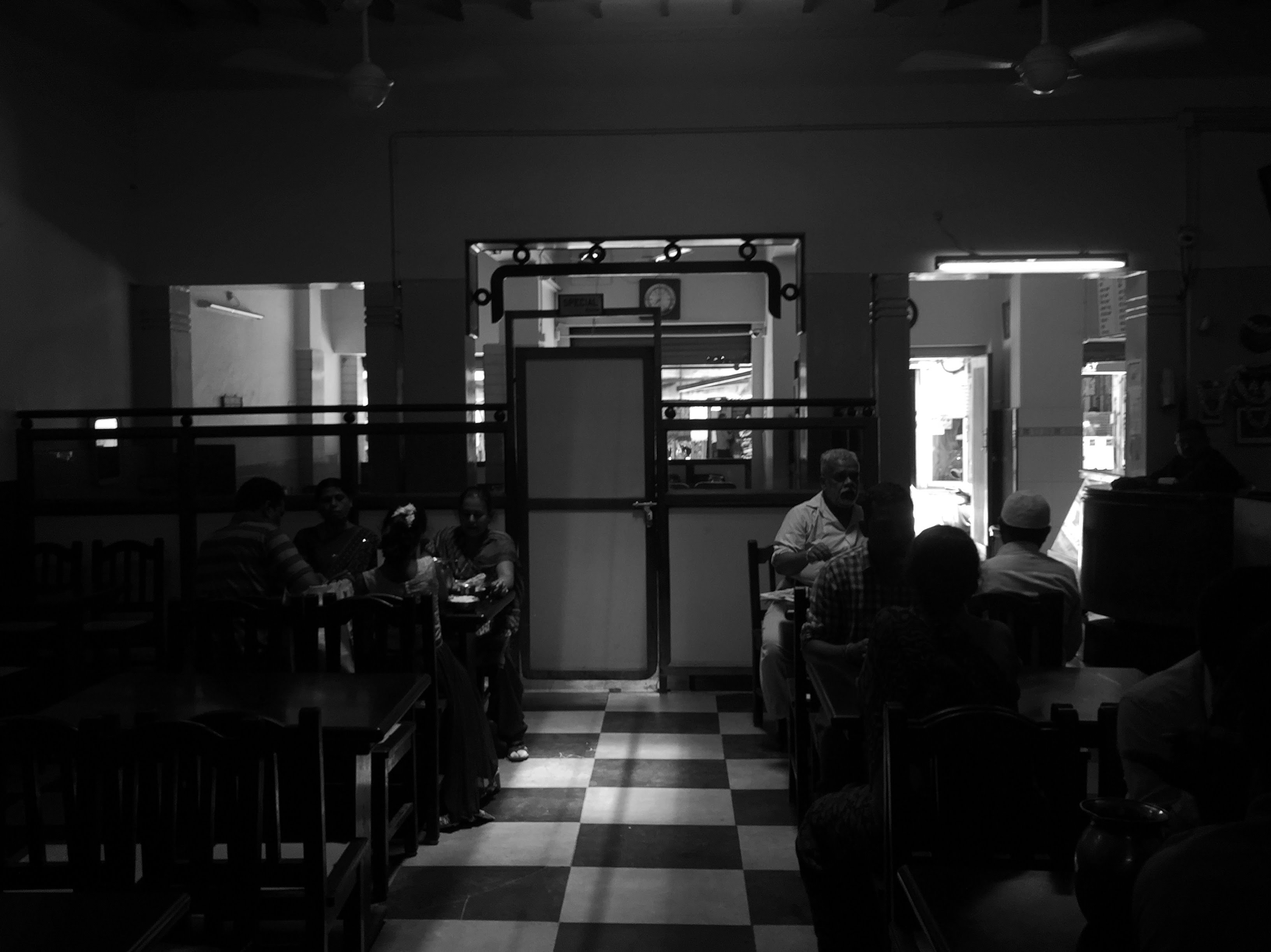 A black and white image of the interiors of Udupi Sri Krishna Bhavan. We ended our walk at this iconic restaurant.
