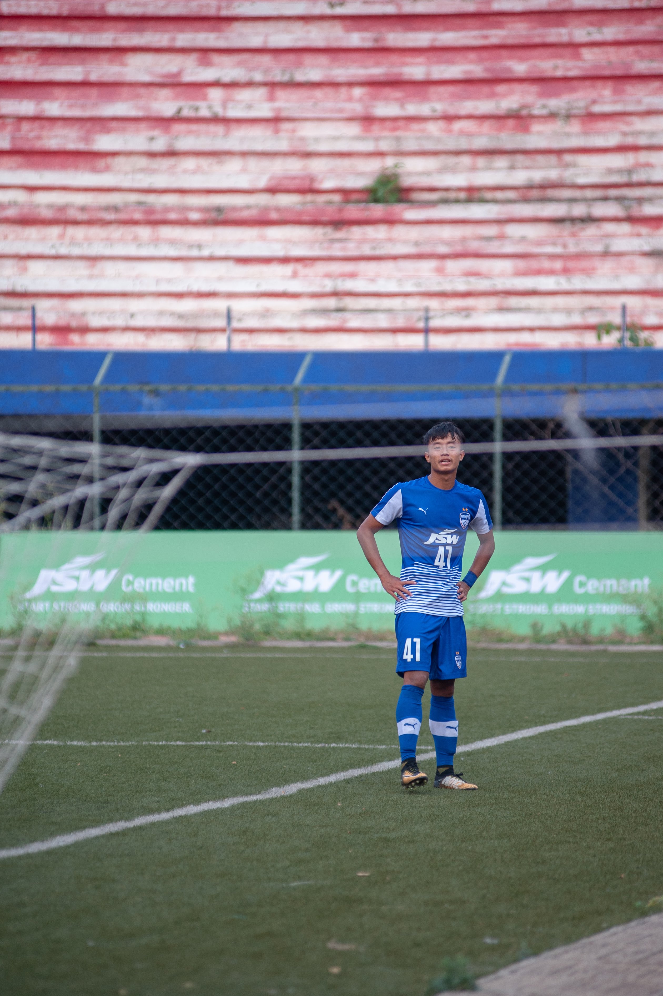 Naorem Roshan is seen standing behind the goal, dejected, after failing to hit the back of the net by a whisker.