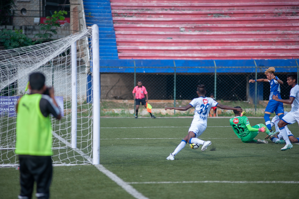 A Chennaiyin defender clear the ball just ahead of the goal line.