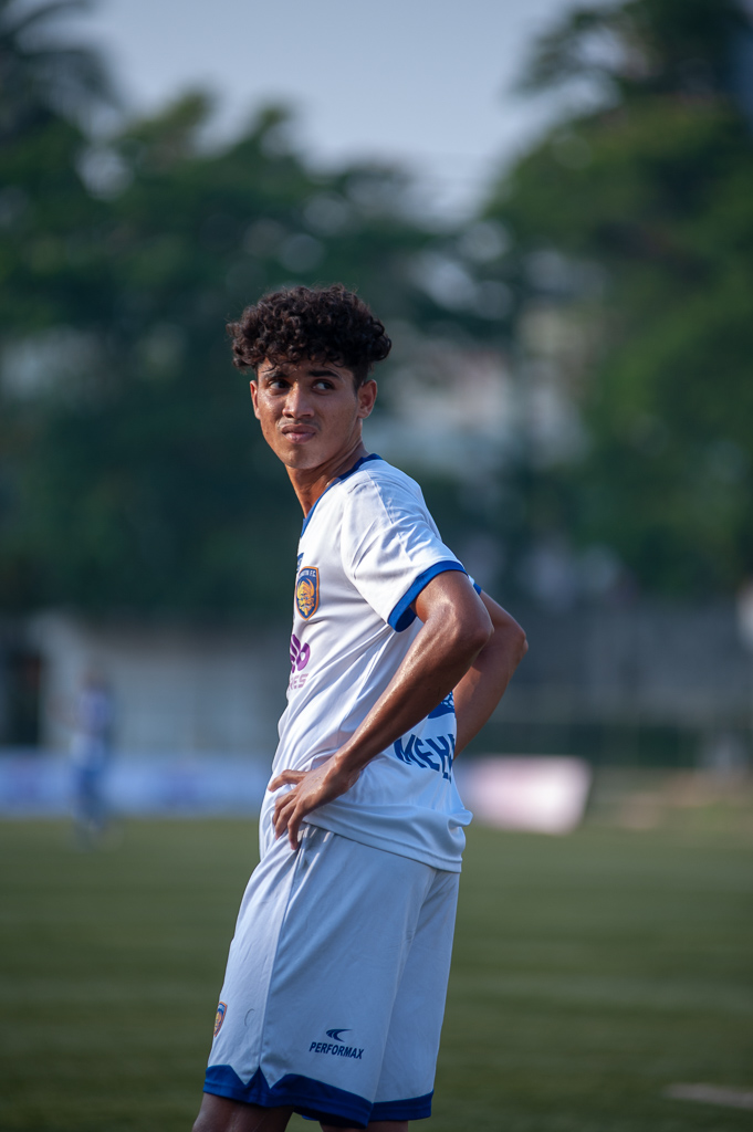 A medium shot of a Chennaiyin FC Reserves defender looks despairingly at the scoreboard behind him.