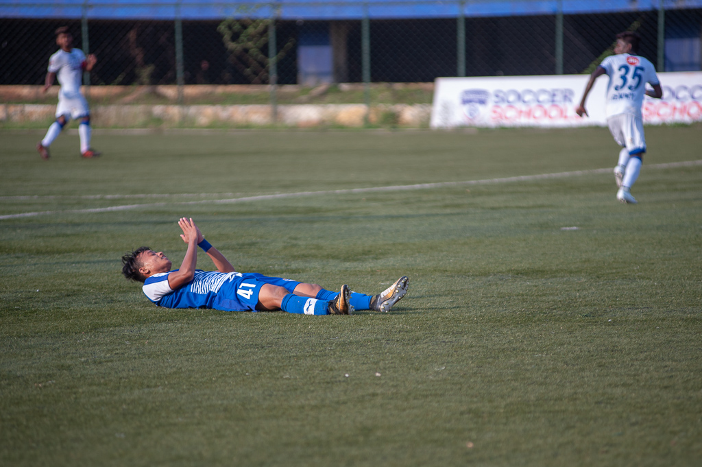 BFC B's Roshan Singh is flat on the ground after sliding to get to the end of a half-chance created by his fellow winger.