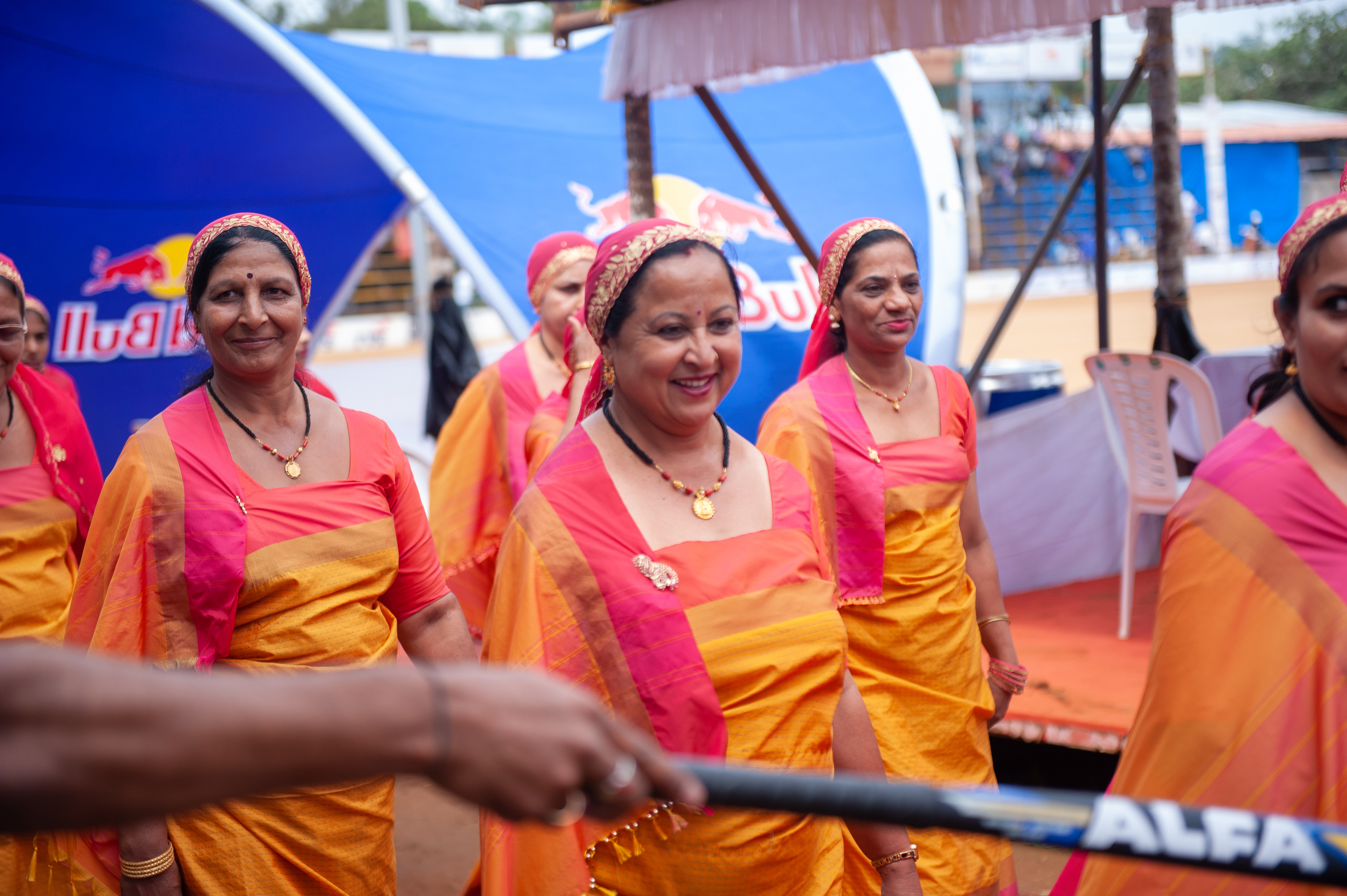 Women dressed in traditional Coorgi attire are seen taking a lap of honor in order to hand off the responsibility to next year’s hosts. 