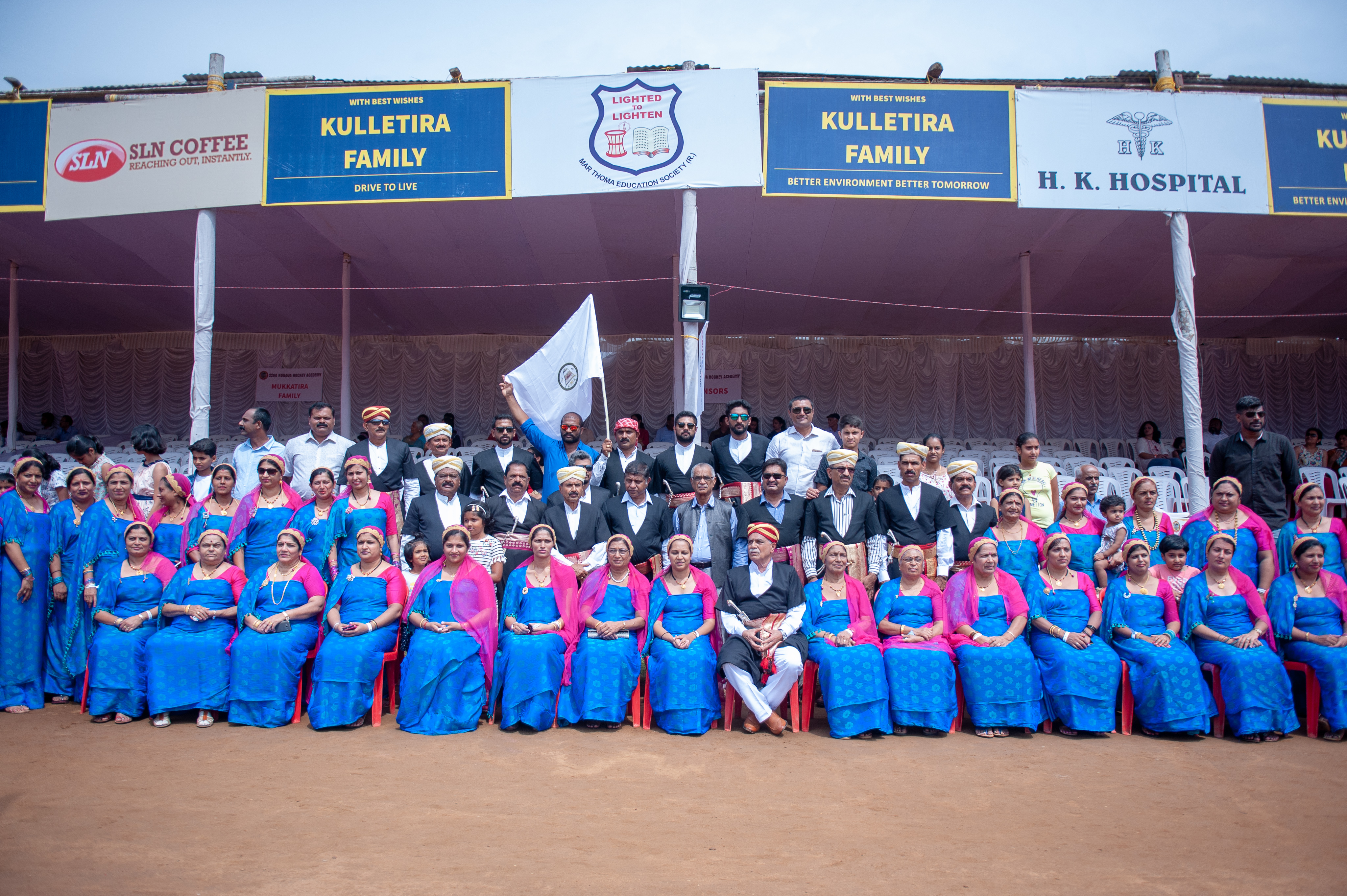 A wide-angled group photo of the Mukkatira family, which will host next year's Kadagu Hockey Festival. The men and woman have adorned traditional Coorgi attire.   